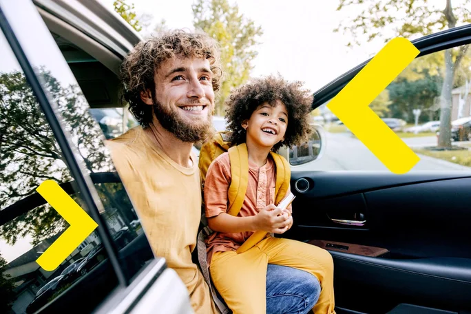 A father and his child laugh happily as they get out of the car. The bright yellow backpacks symbolize adventure and anticipation of an outing or school day together.